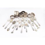 A collection of silver and silver plated napkin rings and souvenir teaspoons