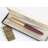 A Parker 61 fountain pen, maroon barrel marked Air India Boeing Inaugural Service, with gilt cap,