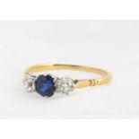 A sapphire and diamond 18ct gold three stone dress ring, the central mixed round cut, weighting 0.