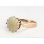 A 9ct gold circular opal ring, the white opal with claw setting on a tapered shank, ring size N1/