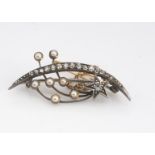 An Edwardian diamond and seed pearl crescent moon and shooting star brooch, 3.9 cm by 1.5 cm 4.4g