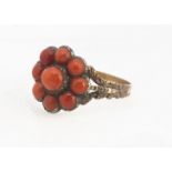 A 19th century coral cluster ring, the silver mount, on a triple engraved floral shoulder, ring size