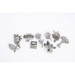 A collection of silver, base metal and paste set brooches, most are of fauna and floral design, some
