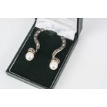 A pair of Antique style diamond and pearl earrings, the twist drops set with rose cut diamonds,