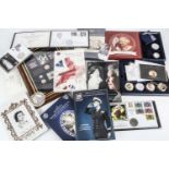 A collection of commemorative coins and medallions and other items, including a 1/200 oz gold