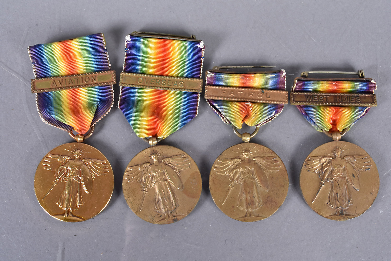 Four WWII and later issue United States Victory medals, all with a single clasp, including Aviation,