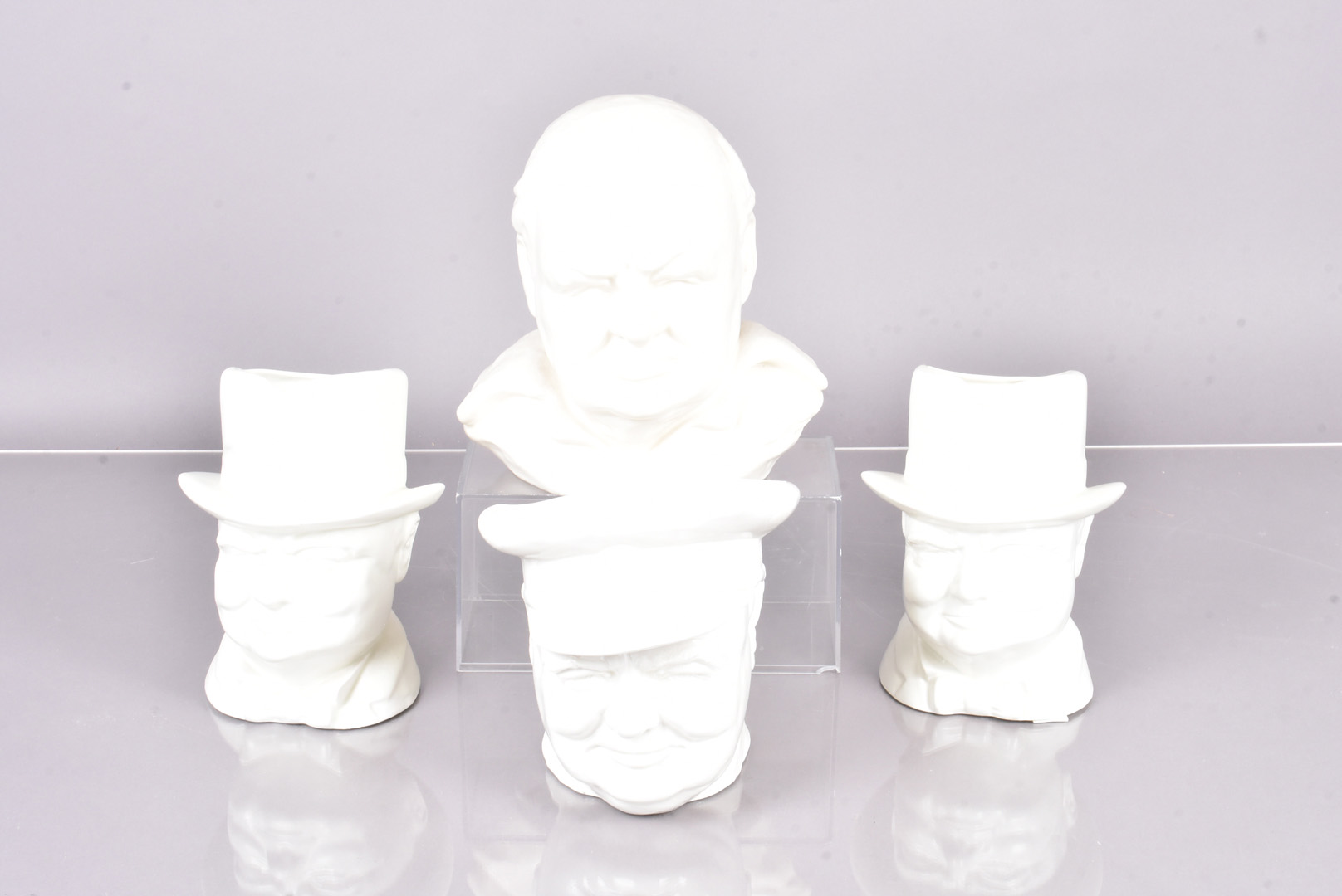 Two Wilton Pottery Winston Churchill Character jugs, both in white glaze, together with a Sylvac