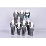 A group of eight early Winston Churchill figures, consisting of wooden and plaster examples, all