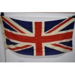 A British Union Jack flag, possibly Naval, no visible stamps, approximately 180cm x 86cm, with