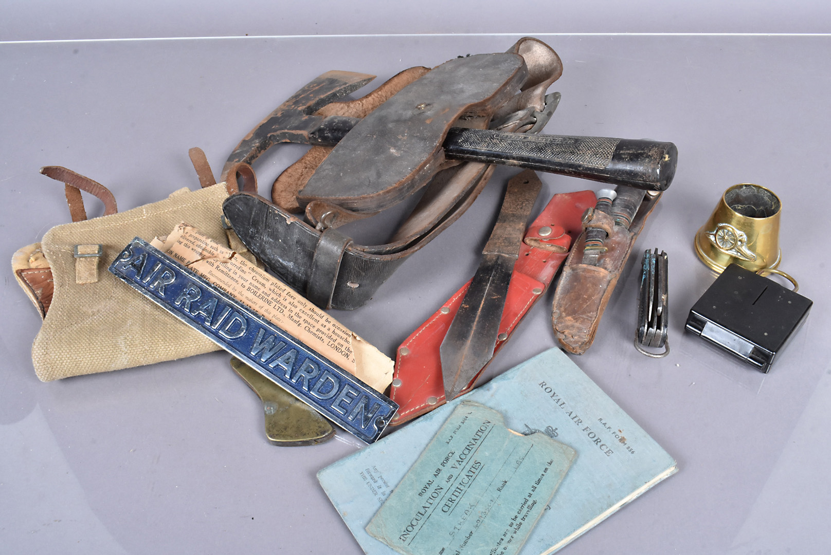 An assortment of various items, to include an axe and carrier, a pair of 1950s gators, a Solingen