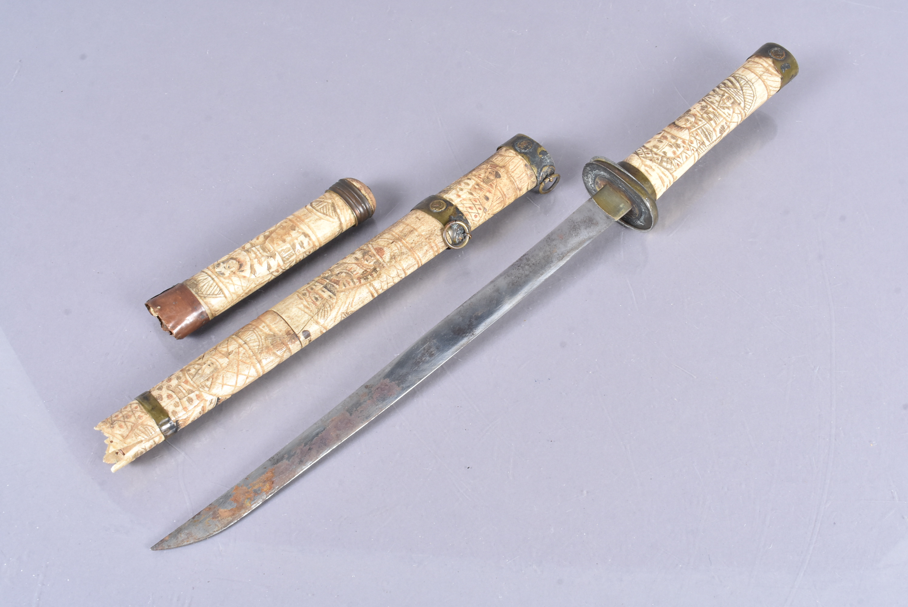 A Chinese Tanto, with carved bone grip and scabbard, with figural decoration, 32cm long single