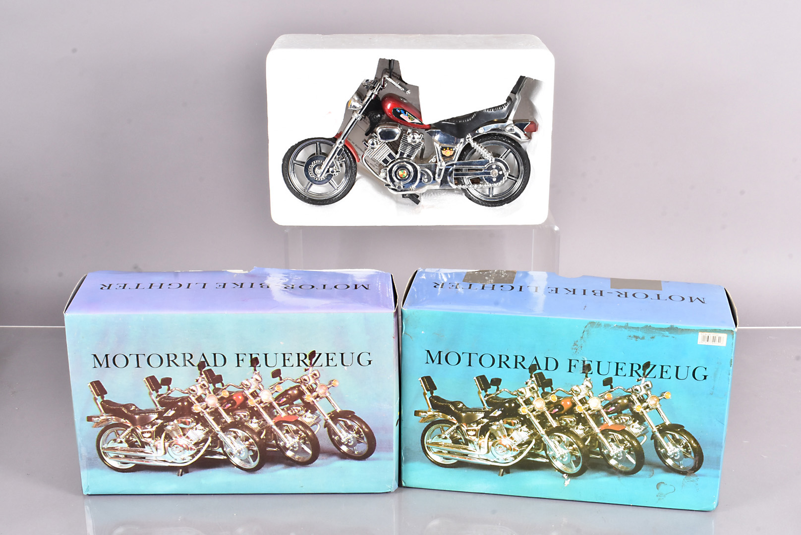 Four boxed novelty desk lighters by Motorrad Feuerzeug, in the forms of motorbikes, in original