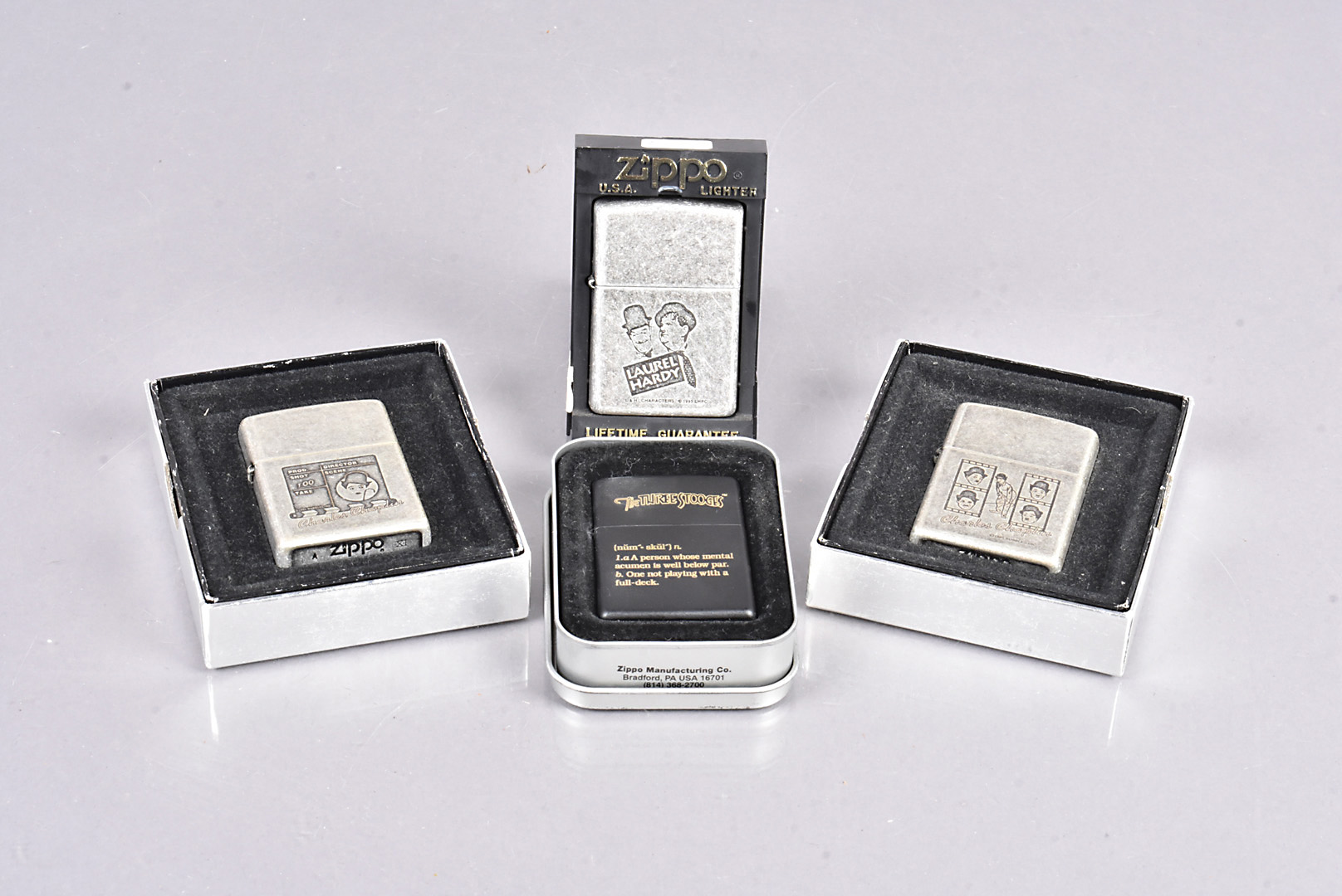 Entertainment, three antique silver plate cased Zippo lighters, one for Laurel & Hardy (95), and two