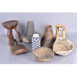 A selection of tribal items, to include two wooden Hima milk jugs, a tripod stool, beadwork