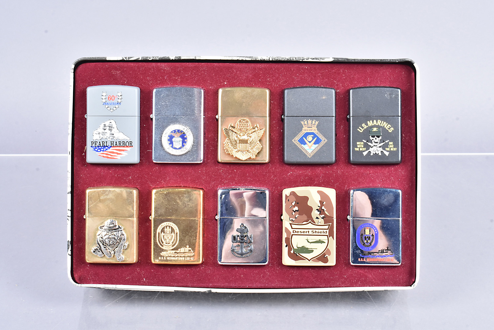 Military, an assortment of 10 American Military related Zippo lighters, to include 60th