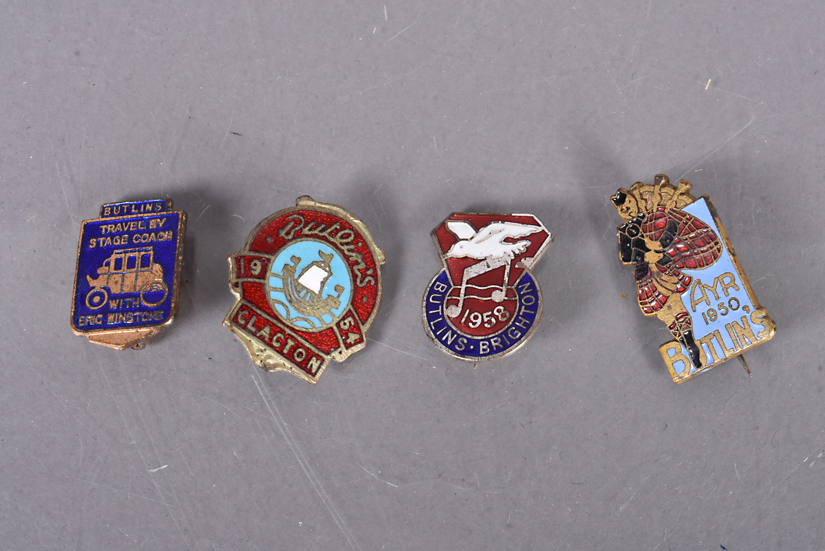Three vintage Butlins pin badges, including the scarce Ayr 1950, Clacton 1954 and Brighton 1958,