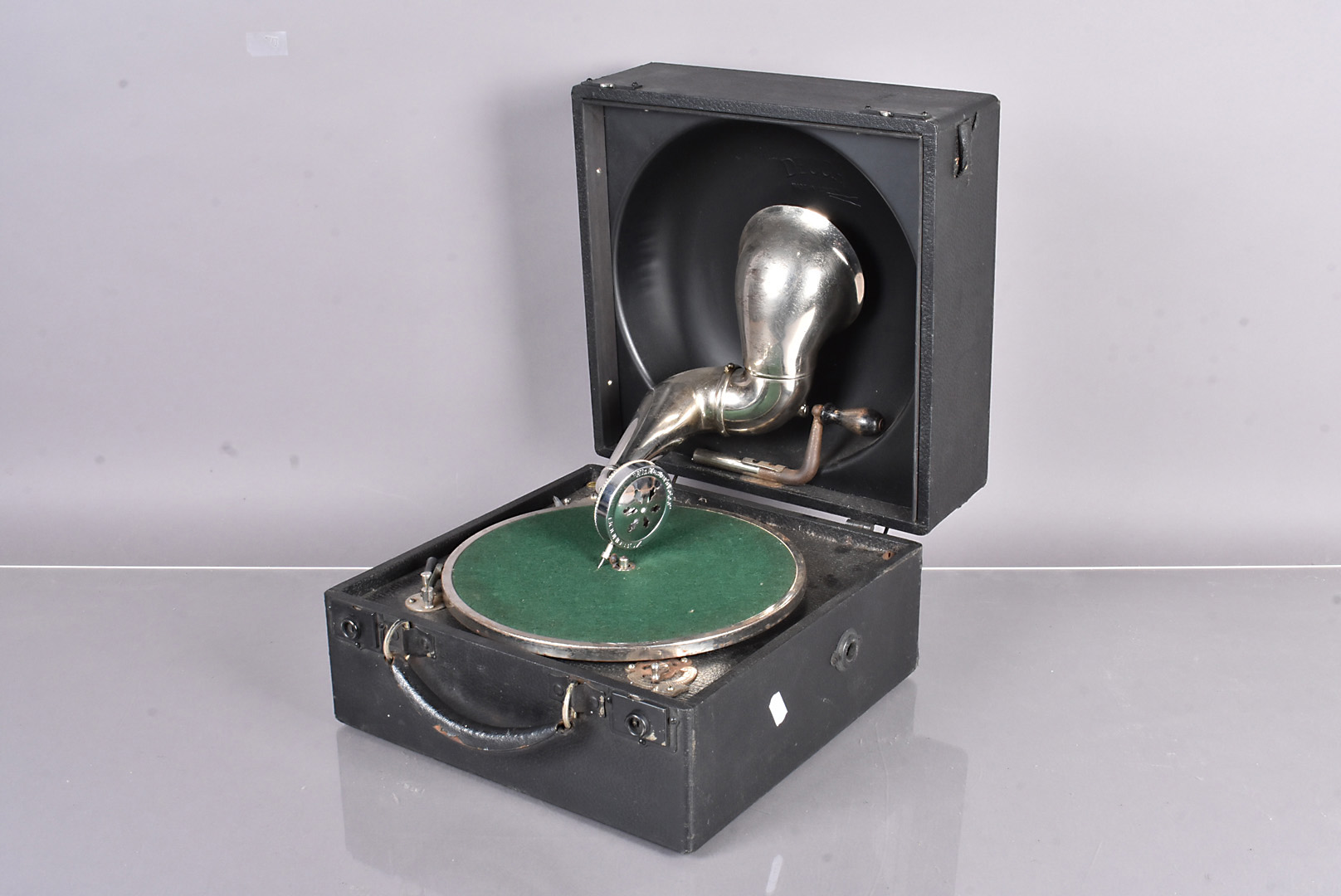 A Decca 'bowl-in-lid' Portable gramophone, with typical reflector dish horn in lid, Decca