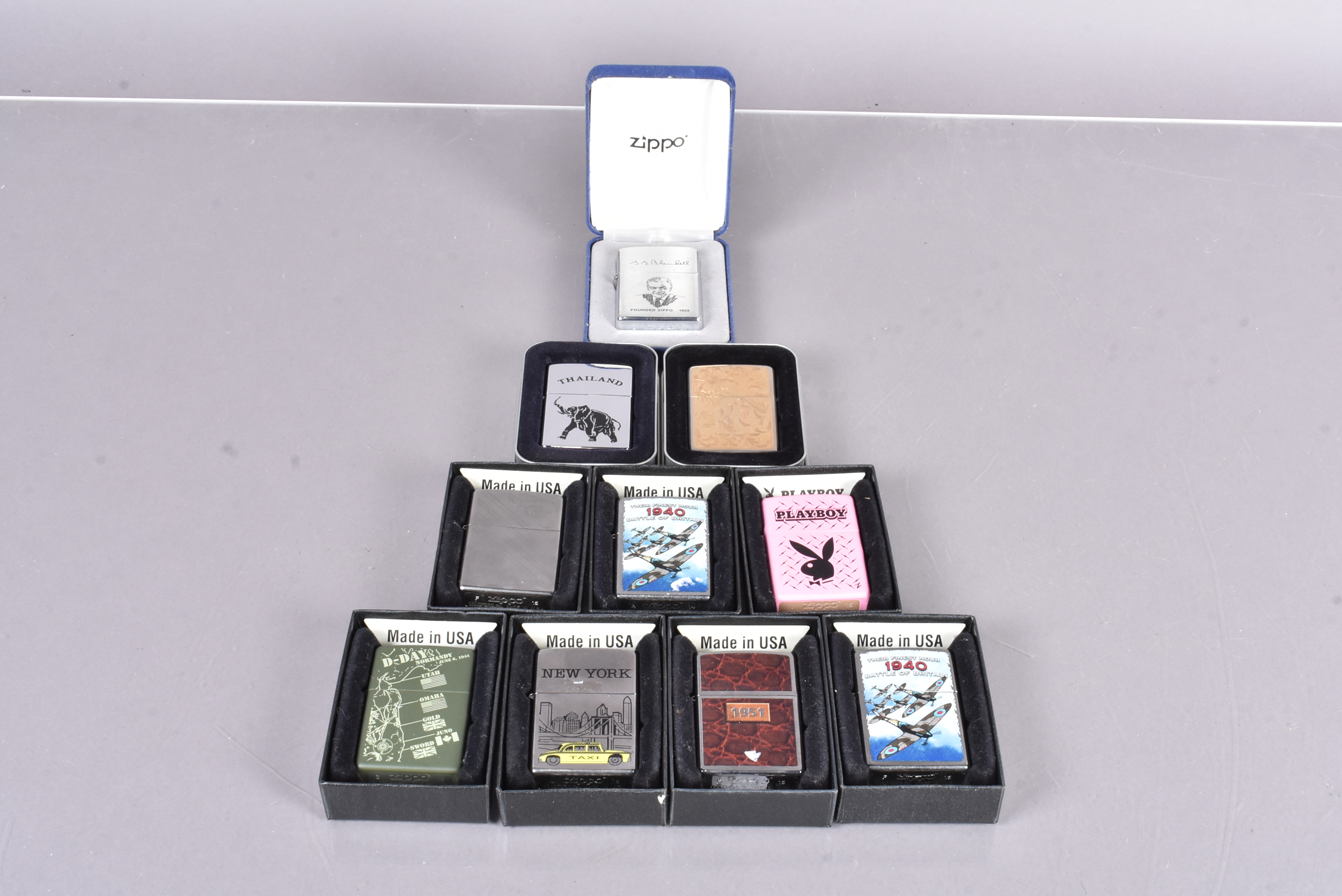 An assortment of Zippo lighters, to include D-Day Normandy, New York Taxi, Battle of Britain,