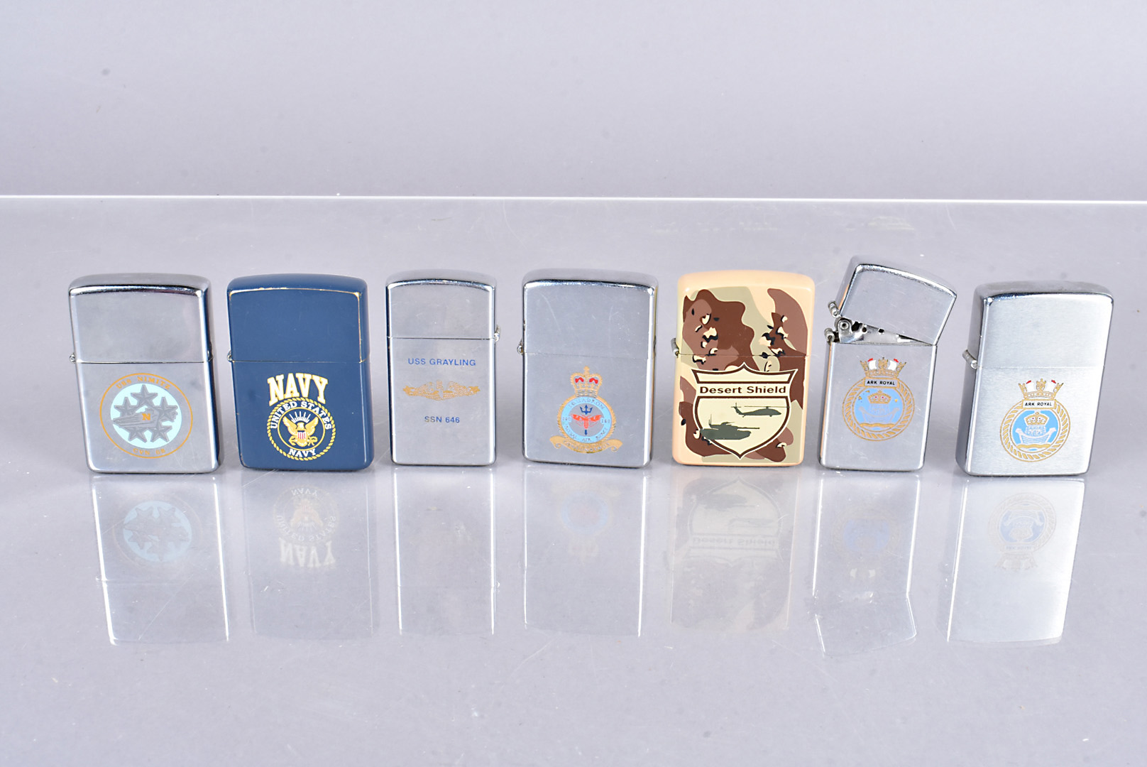 A collection of Military related Zippos, dated 1978 to 1995, with different insignia and designs,