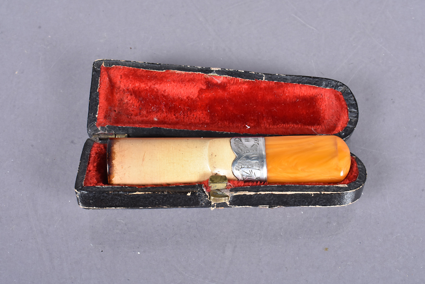 An early 20th Century cheroot, with hallmarked silver collar with amber tip, dated Chester 1901,