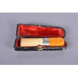 An early 20th Century cheroot, with hallmarked silver collar with amber tip, dated Chester 1901,