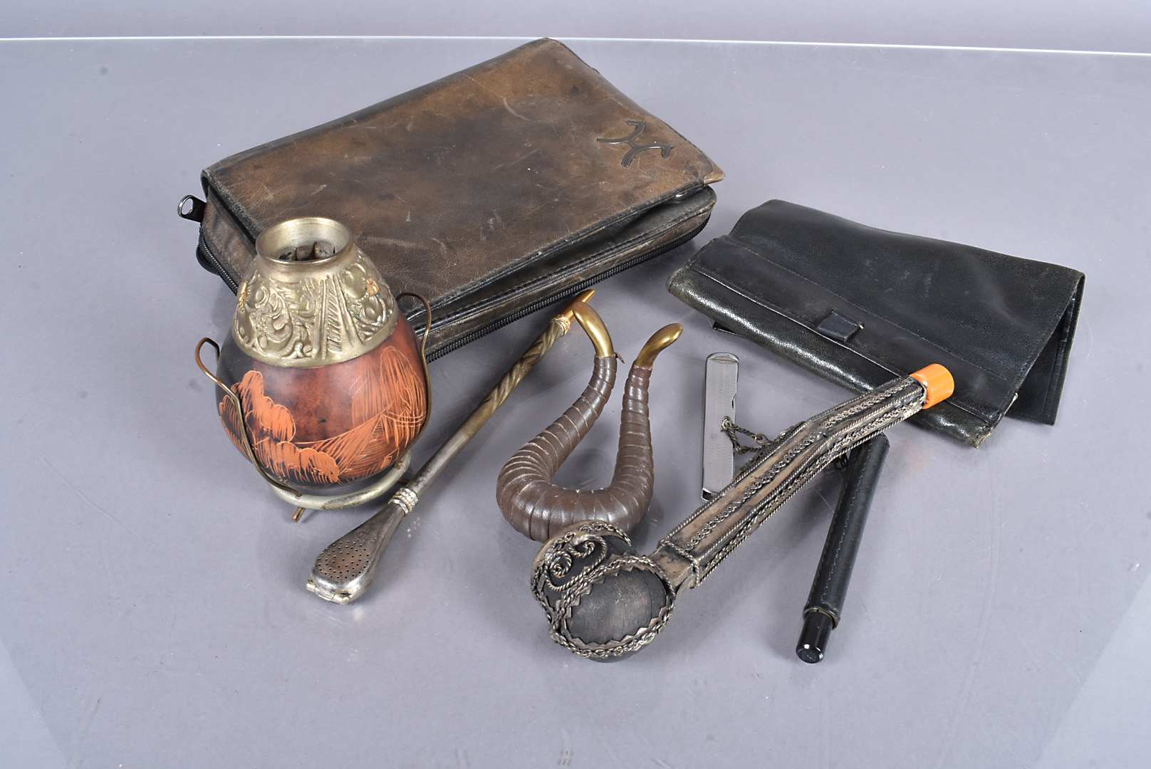 A small collection of smoking pipe related items, to include a Middle Eastern Pipe, two carry