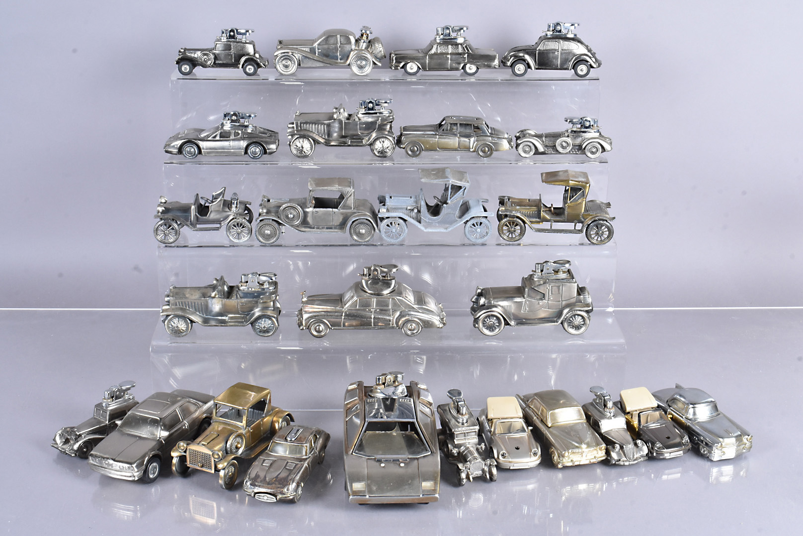 A collection of cast model desk/table lighters, in the forms of cars, including Buick 1911, Opel