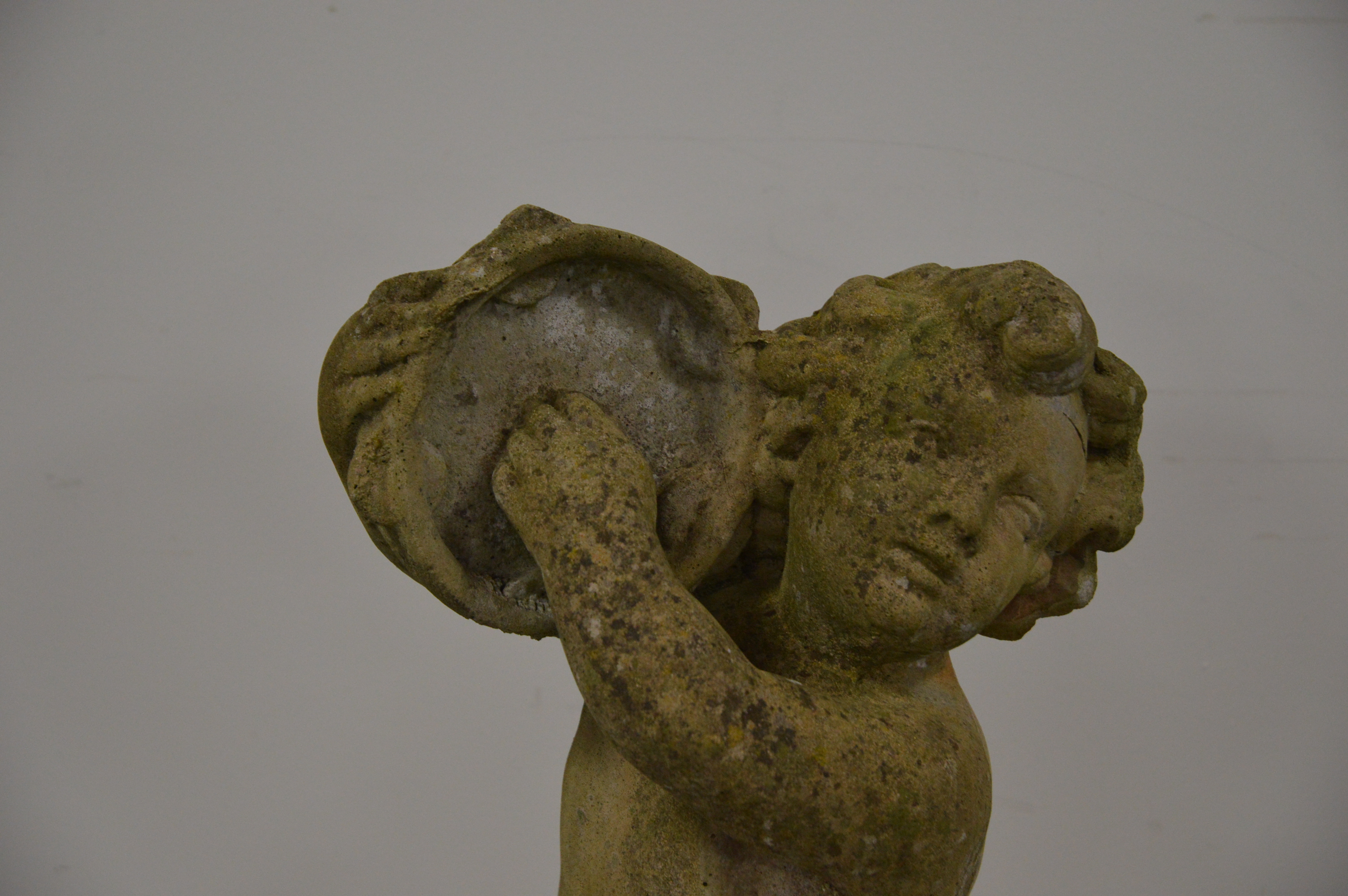 A cast garden figure of a cherub, playing a tambourine. 101 cm tall. Some wear and weathering. AF ( - Image 2 of 2
