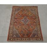 A 20th century geometric pattern woollen rug, faded and with some wear, AF 158cm x 107cm