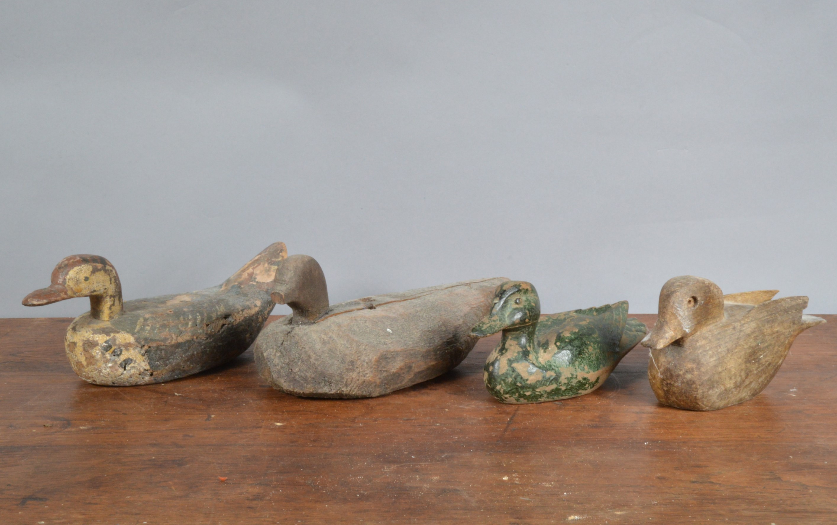 Four 19th century and later primitive decoy ducks, three wooden one sponge bodied example, hand