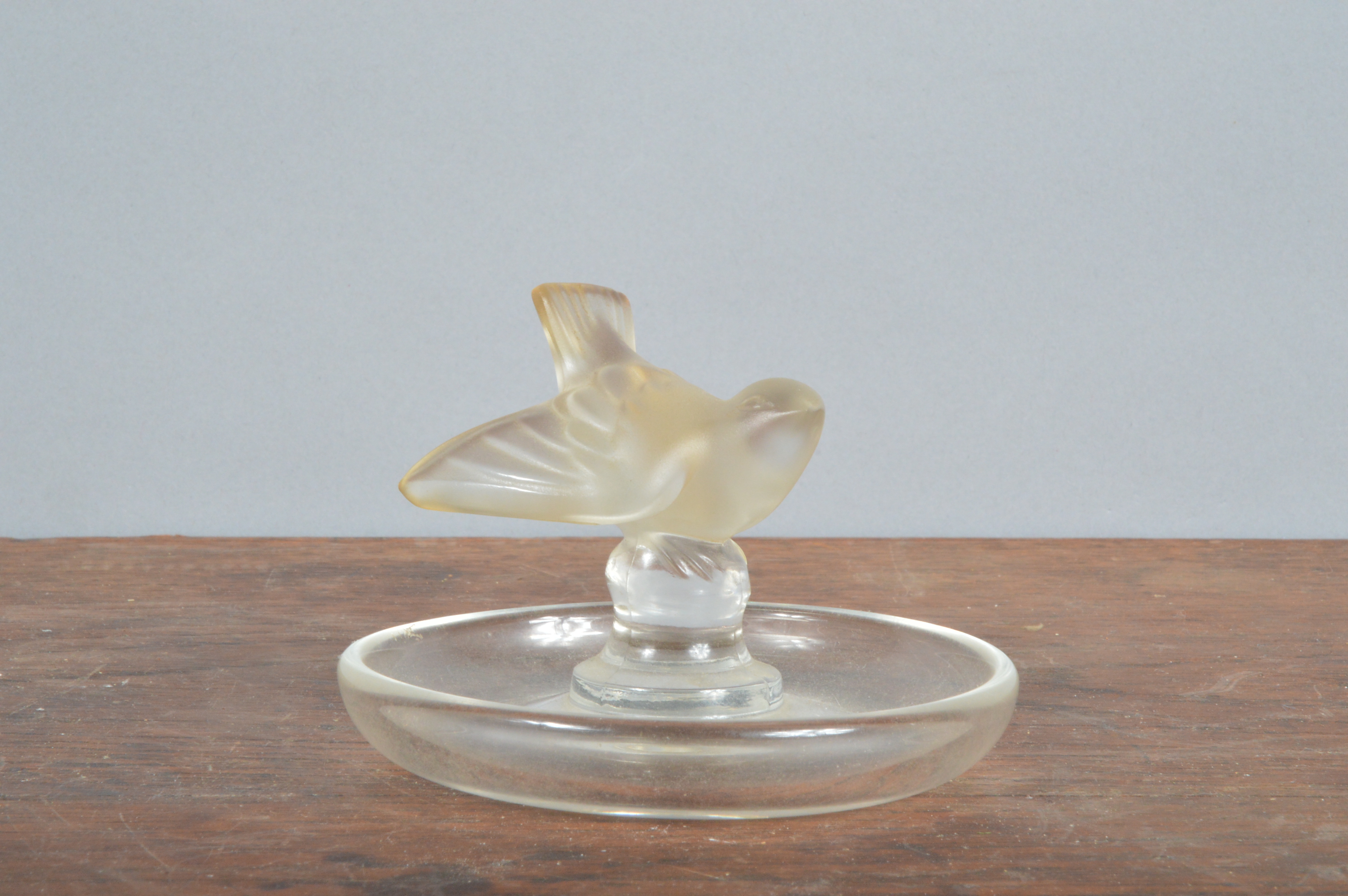 A 20th century Lalique France ashtray, marked to the underside modelled as a bird with