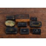 A collection of mostly 19th century papier mache snuff boxes, most with decorative inlay and