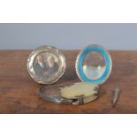 A small silver-mounted photo frame, 7.5cm diameter, a white metal and blue enamel oval photo