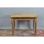A Victorian pitch pine kitchen table, rectangular top, one drawer to the side, on turned supports,