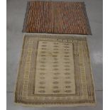 Two rugs, one a stained cream tekke style 137cm x 127cm and a multi coloured wool on wool striped