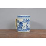 A 19th century Chinese blue and white hand-painted tankard, decorated with a landscape scene with