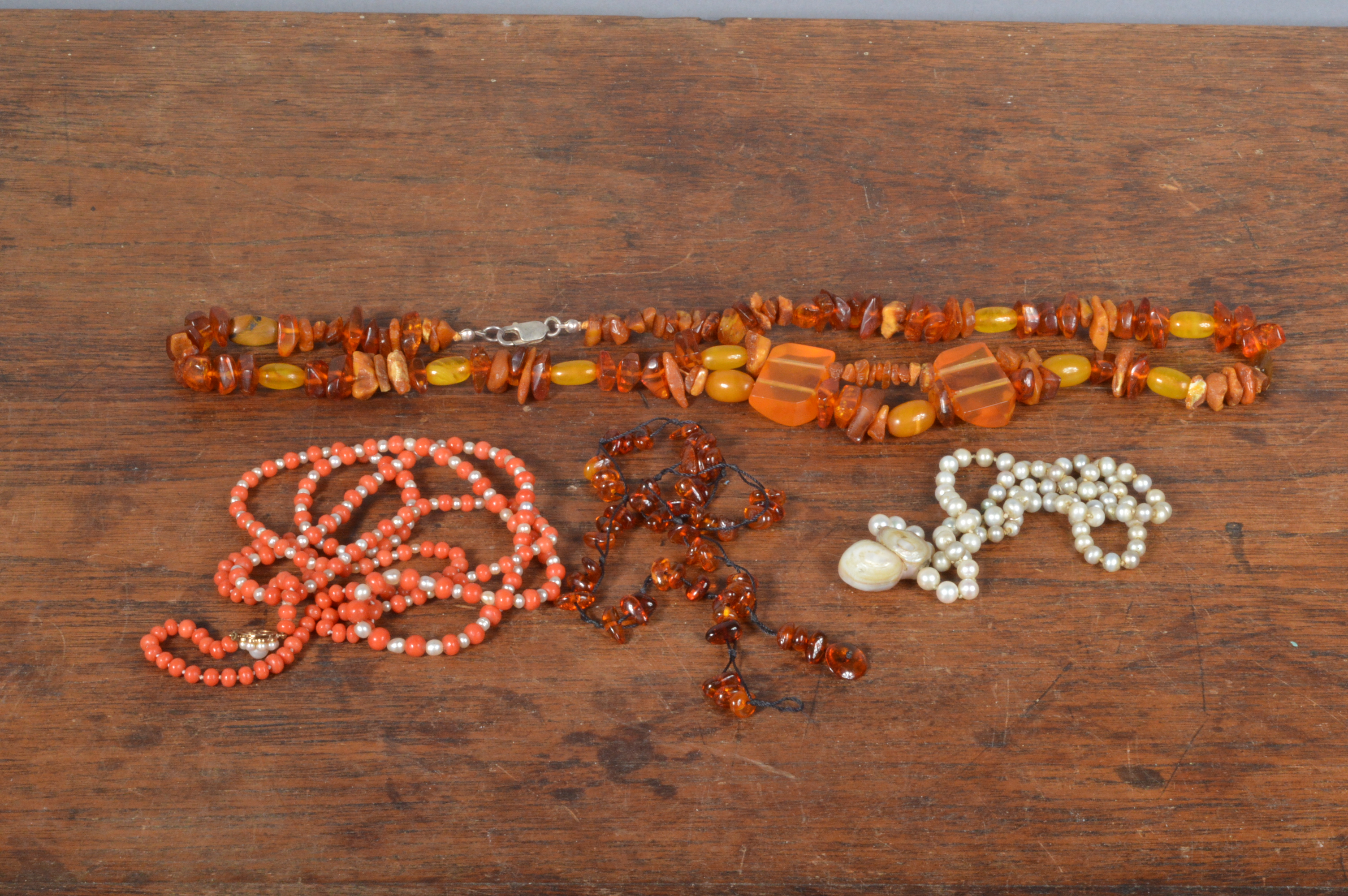 A small collection of organic jewels, including a string of coral and seed pearl beads on a 9ct gold