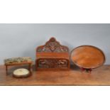 A gothic carved foldable newspaper shelf, together with a mahogany tray with scalloped gallery, 38cm