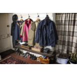 A collection of country clothing, to include Barbour, rain coats, a tweed coat, etc, in poor