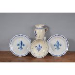 A group of 19th century French faience wares, to include a bowl, a jug and two plates each decorated