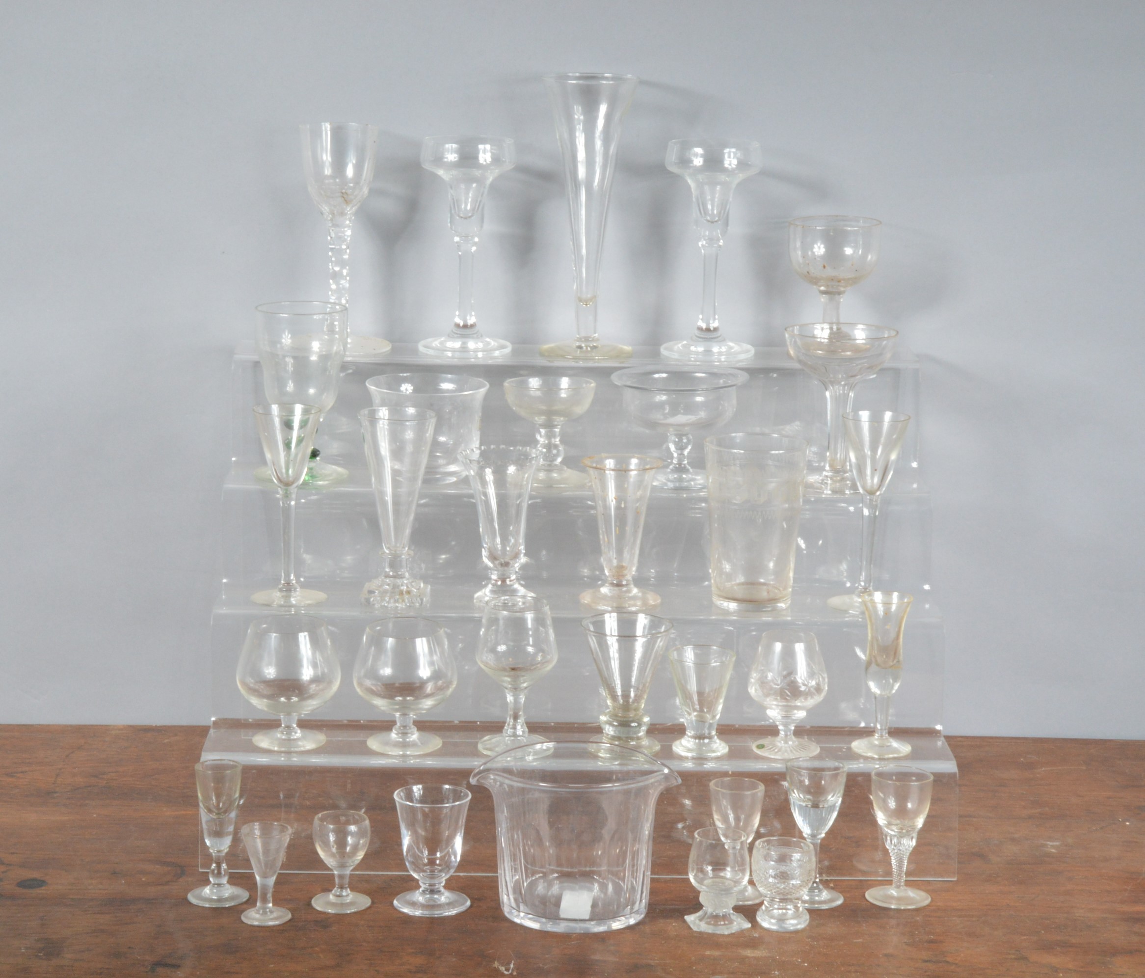 A collection of glassware, mostly drinking glasses, for port, sherry, champagne the largest flute