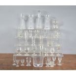 A collection of glassware, mostly drinking glasses, for port, sherry, champagne the largest flute