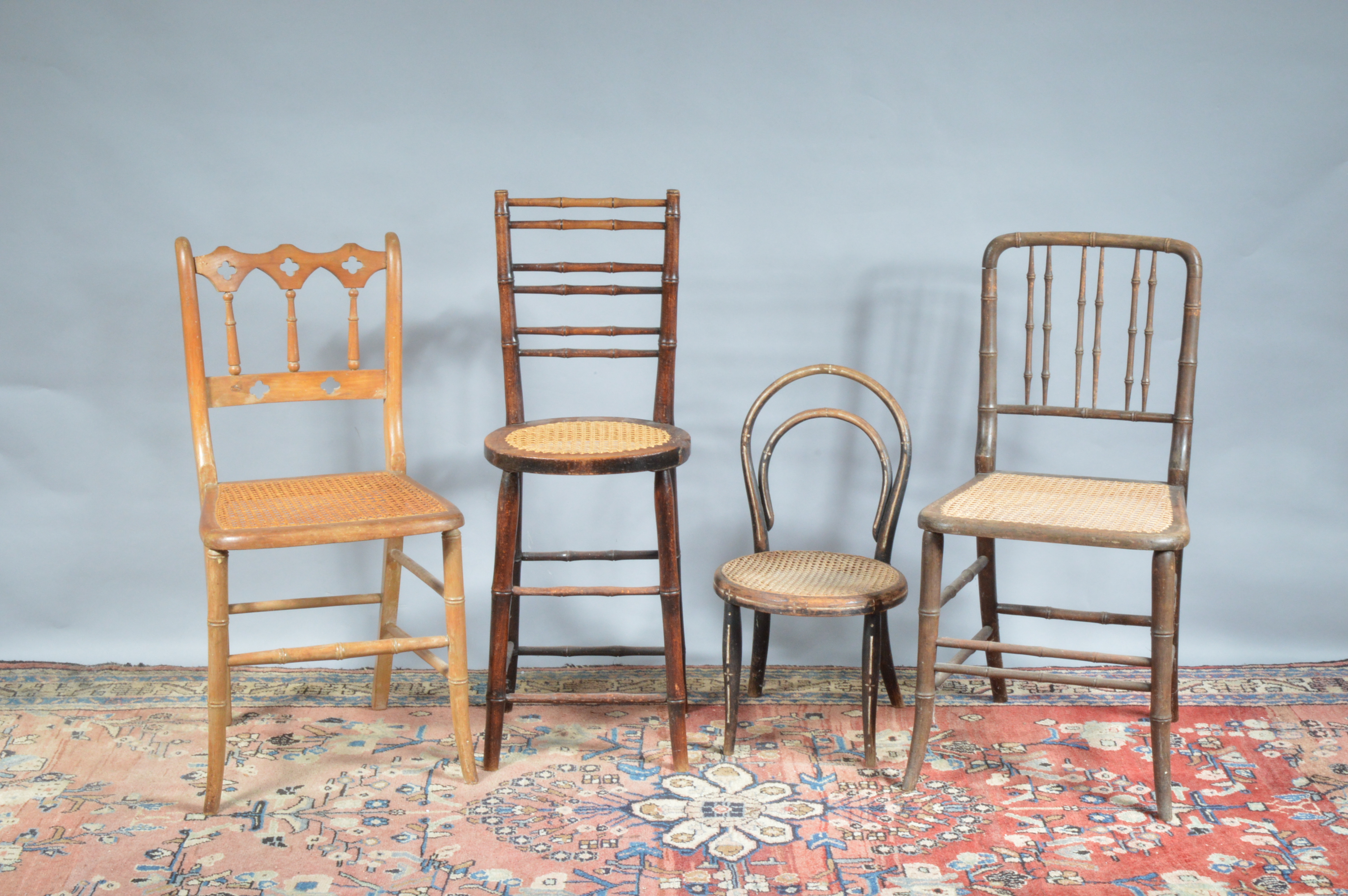 Four 19th century and later caned seats, differing styles and sizes, one a high seat with bamboo