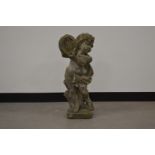 A cast garden cherub, of moulded form, holding a harp. 71 cm tall. Some wear and weathering. AF (1)