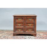 A 19th century elm storage box, lift open lid (cracked), faux draw front with brass handles, with