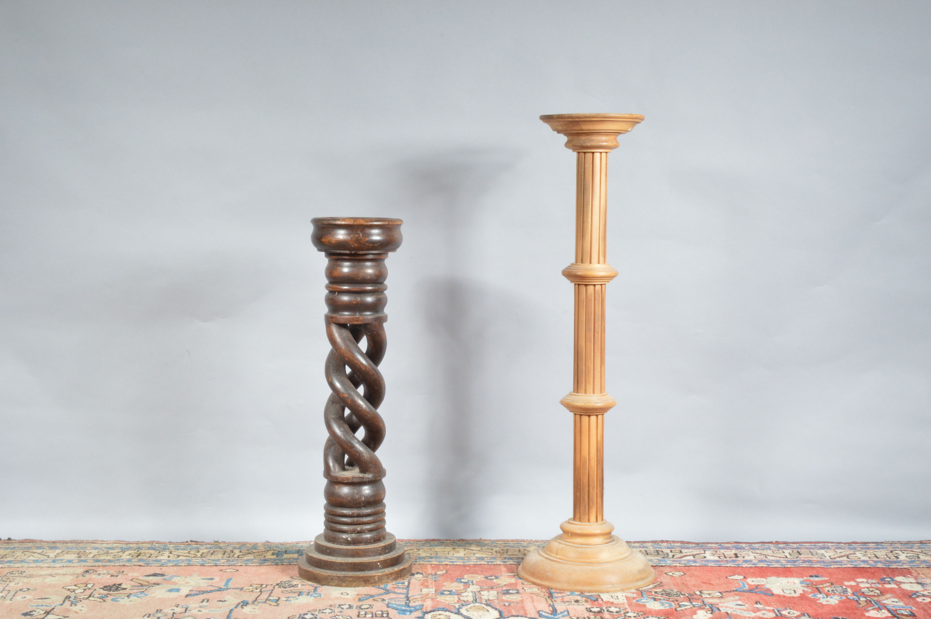 Two wooden jardinieres, one with a pierced spiral column, the other taller one lighter and with a
