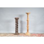 Two wooden jardinieres, one with a pierced spiral column, the other taller one lighter and with a