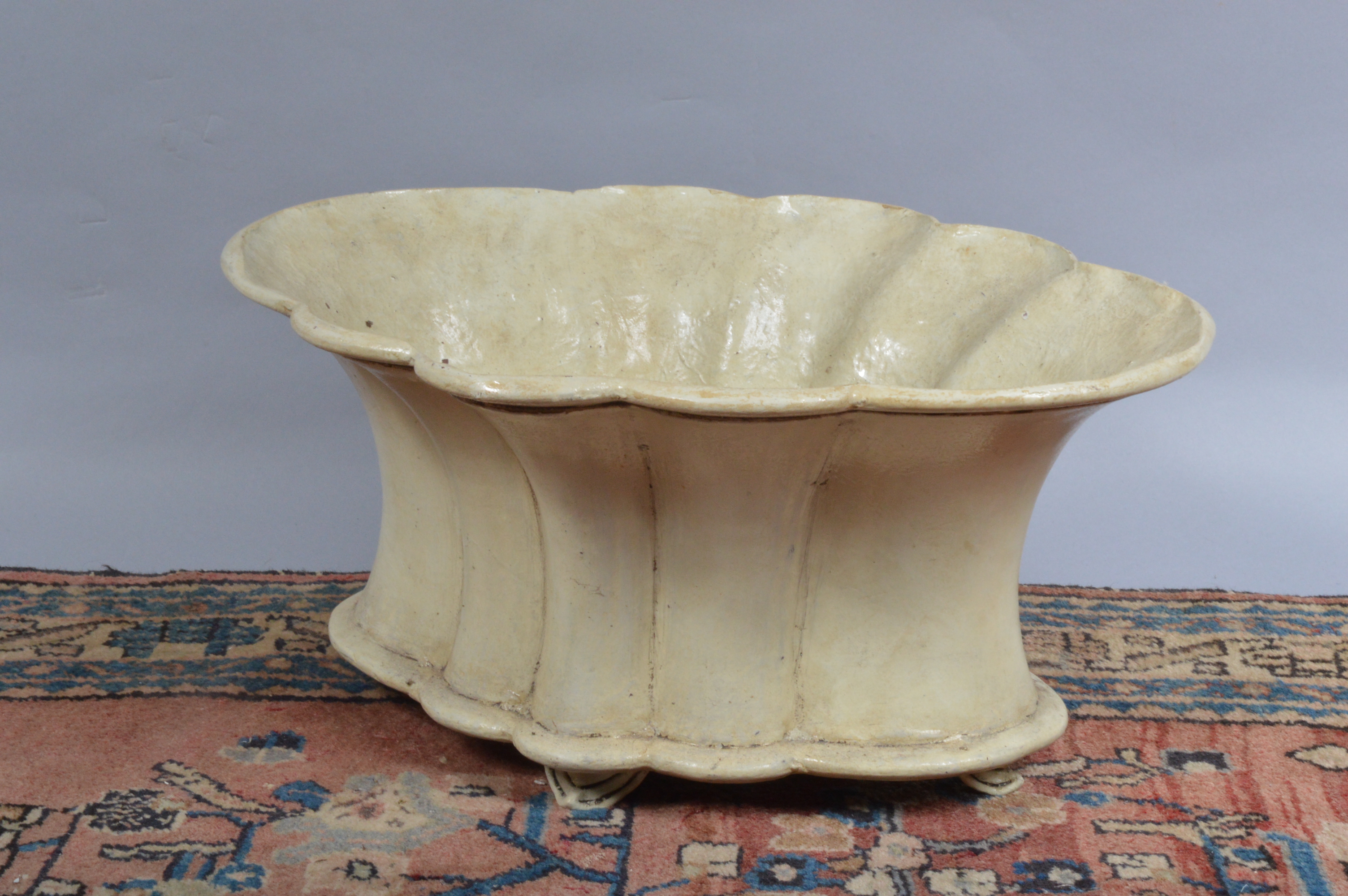 A fibre glass planter, scalloped shape, cream coloured, 54 cm wide. (1)