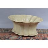 A fibre glass planter, scalloped shape, cream coloured, 54 cm wide. (1)