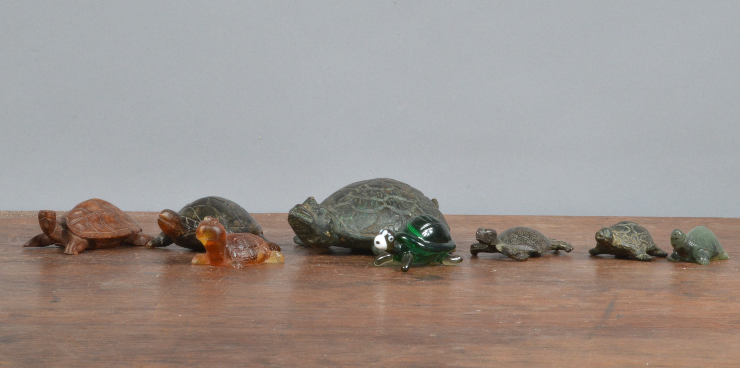 A collection of assorted turtle figurines, comprising a large cast metal example 12cm in length,
